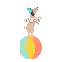 die-cut paper napkins in the shape of a circus dog performer wearing a ruffled collar and cone hat with shiny gold print pom poms and on a colorful ball