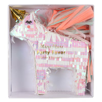 mini unicorn party favor pinata packaged in box, unicorn is made of iridescent fringe paper and has a gold unicorn horn and multicolor paper tail filled with confetti and two temporary tattoos, room for additional small treats.