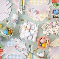 easter party decors options including gingham plates, napkins and a soft pink hopping bunny with multi-color pastel flower crown on bunny 