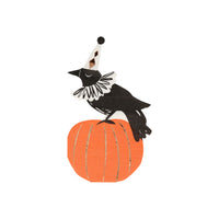 Vintage inspired paper party napkins featuring a crow with a decorative collar, tall cone party hat and is perched on an orange pumpkin with gold foil stripe details. High quality die-cut party napkins 