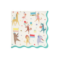 A square paper party napkin with scalloped edges, featuring a whimsical animal parade print on a white background. The design includes a alligator, giraffe, flamingo, monkey, bear, lion, and elephant holding flags and balloons, surrounded by confetti and gold foil stars. Green Border
