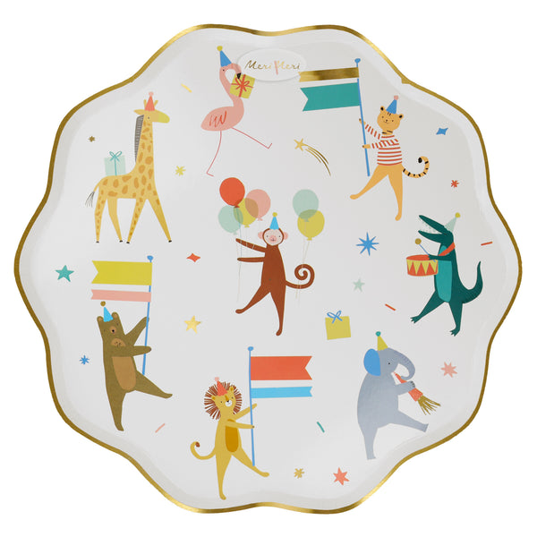 A scalloped white plate with gold foil edge trim featuring a colorful animal parade including drumming alligator, horn playing elephant, marching bear, lion, cat, giraffe, flamingo and a monkey at the center with a party hat and bunch of balloons.