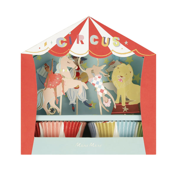 A circus-themed cupcake gift box featuring a red and white striped tent design with the word 'CIRCUS' on the front, a colorful illustration of carousel animals and performers, and two rows of striped paper cupcake liners visible inside.
