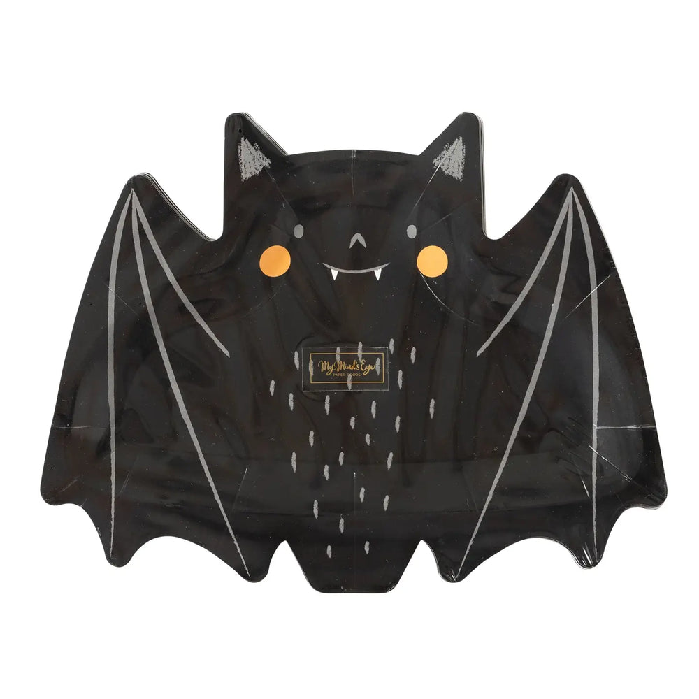 Smily face bats are made of paper and die-cut into the shape of a bat with wings spread open. Black bat with round orange cheeks and white fangs and white highlights on wings, ears and body to enhance the bat.
