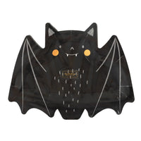 Smily face bats are made of paper and die-cut into the shape of a bat with wings spread open. Black bat with round orange cheeks and white fangs and white highlights on wings, ears and body to enhance the bat.

