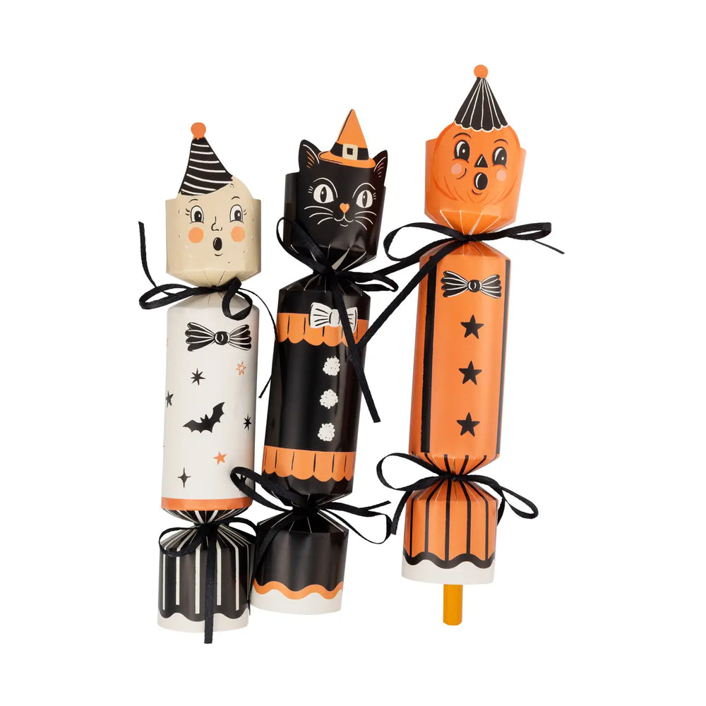 Party crackers, one black cat, one orange jack o’lantern and one man in the moon, tied off with black sating ribbon