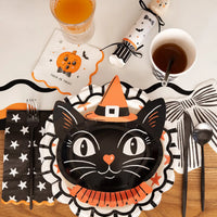 Halloween vintage inspired black cat paper party plate shown with a complete place setting including dinner napkins, beverage napkins, cups and party cracker favor.