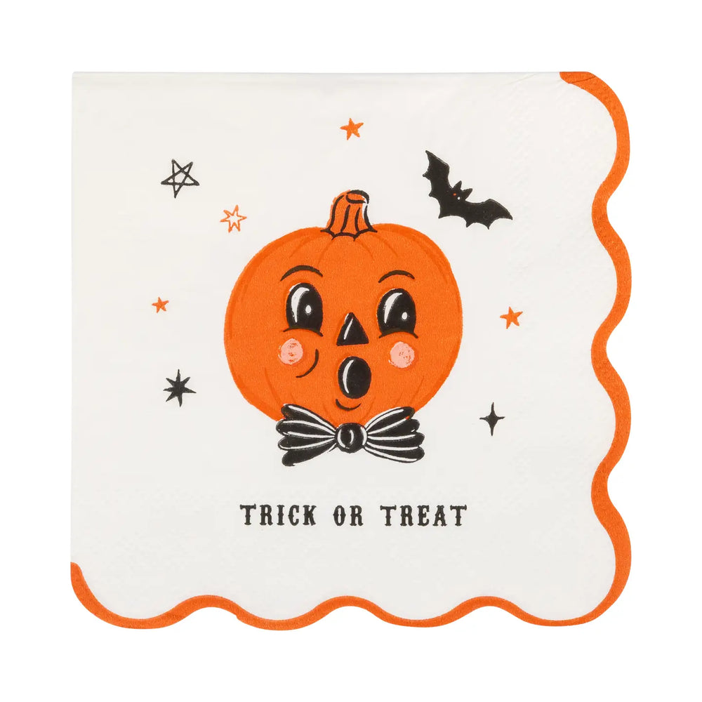 A square cream color paper napkin with scalloped orange edges, featuring a cute cartoon jack-o'-lantern face with a black bow tie, surrounded by small orange stars, a black bat, and the words 'TRICK OR TREAT' at the bottom.