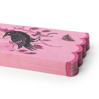 A stack of 20 pink paper guest towel /napkins with scalloped edges, decorated with a black raven, pink flowers, and a butterfly on a white background.