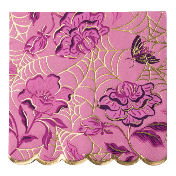 A square pink and purple floral print paper napkin with a scalloped gold edge, featuring a metallic gold foil pattern of spiderwebs, roses, and a butterfly on a pink background.