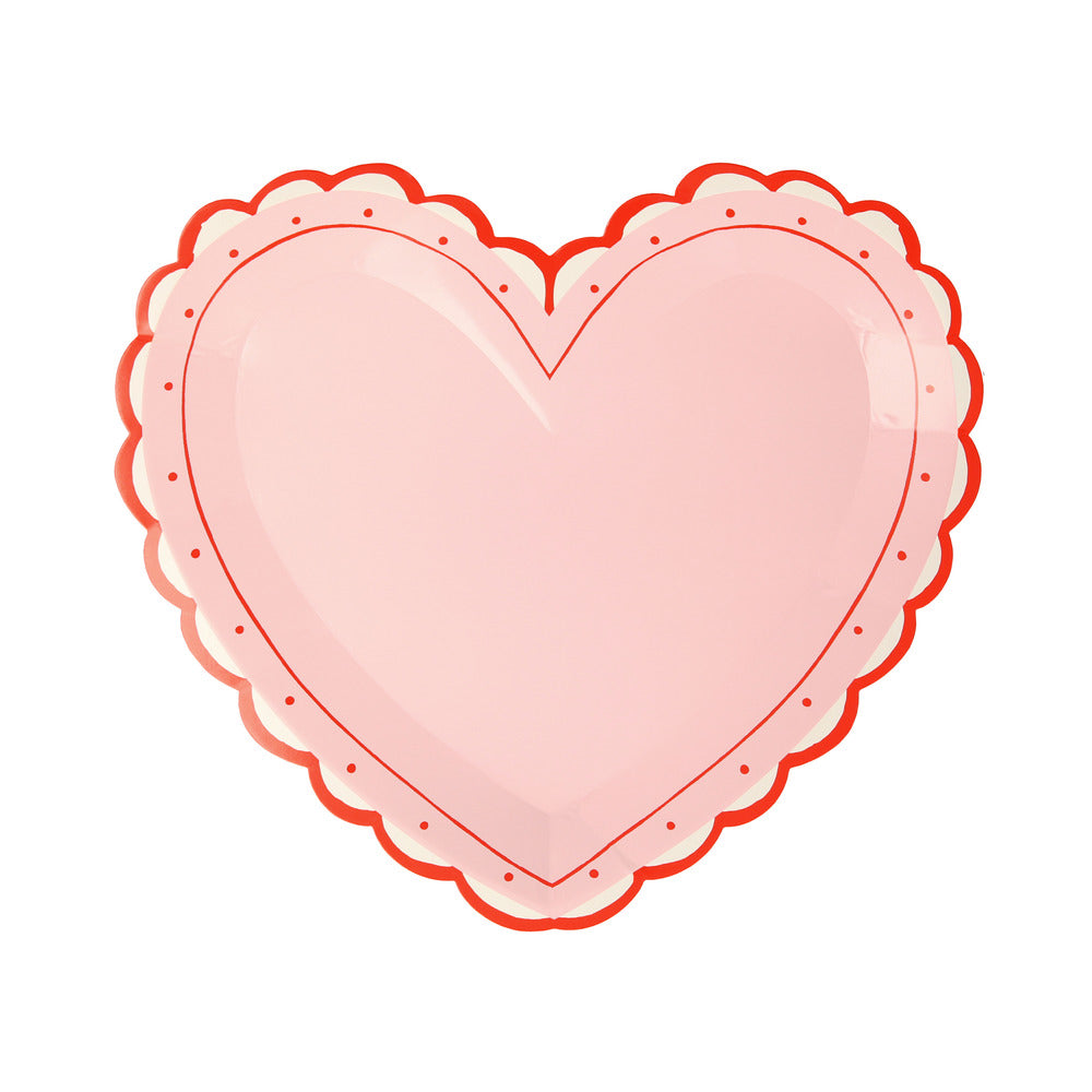 Pink heart shaped plate with a lacy scalloped edge detail in red 