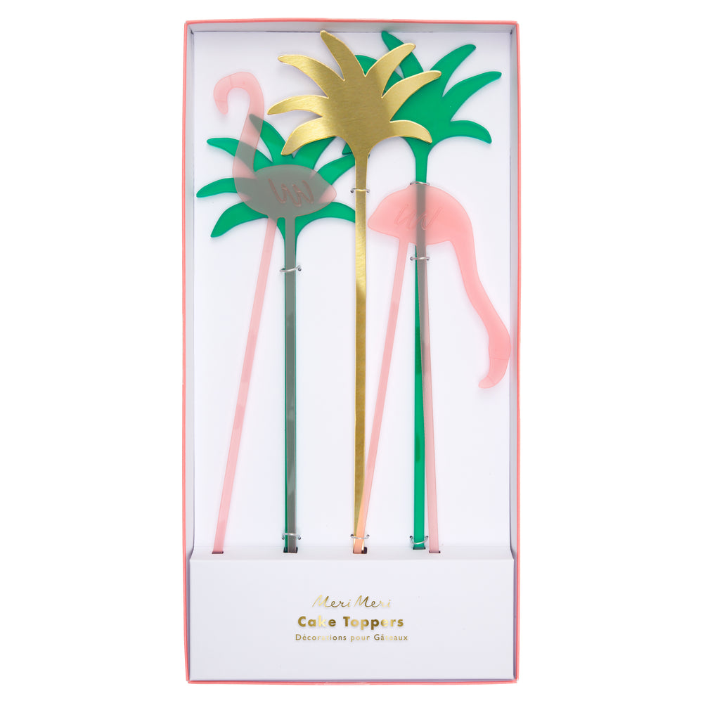pink flamingo cake toppers made from acrylic, includes two green and one gold abstract palm trees package in a box with a clear top.