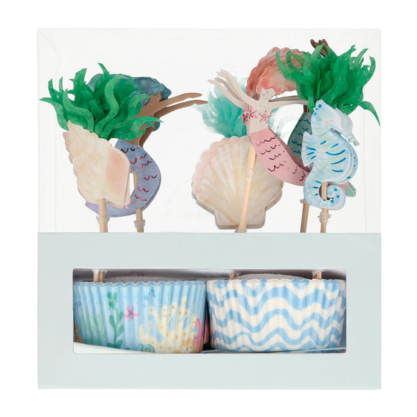 Featuring watercolor illustrations of swimming mermaids, seashells, seahorse made of paper card-stock and seaweed  made of shades of green tissue paper i  n a set of twenty four toppers and baking cases