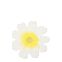 white paper napkin die-cut into the shape of a flower with a yellow center.