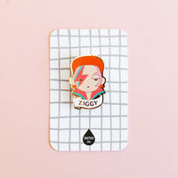 David Bowie " Ziggy " enamel brooch packaged on a windowpane card is the perfect gift or party favor